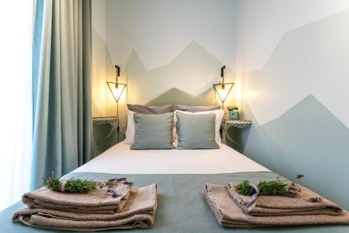 a bedroom with a bed with towels on it at Casas da Formosa - Downtown Alegria in Tavira