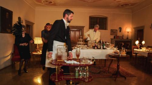 a group of people standing around a table in a room at Weisses Rössl in Caldaro