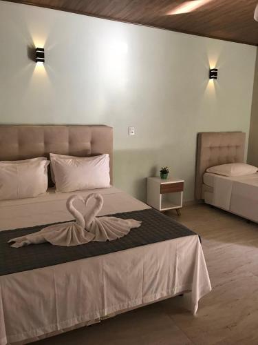 a bedroom with a bed with two hearts on it at Recanto da Roca in Domingos Martins