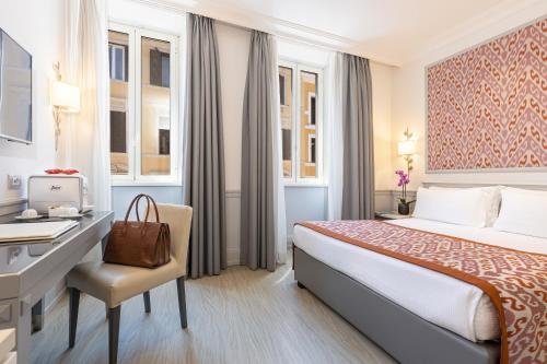 Un pat sau paturi într-o cameră la Hotel Della Conciliazione