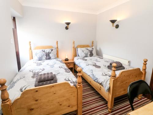 En eller flere senge i et værelse på Ashford Cottage