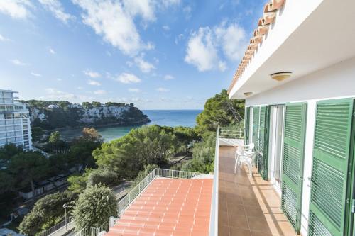 a balcony with a view of the ocean at Miramar L by Sonne Villas in Cala Galdana