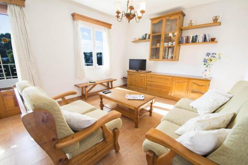 a living room with two couches and a tv at Miramar L by Sonne Villas in Cala Galdana
