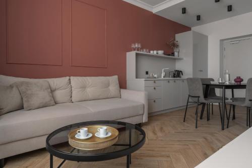 a living room with a couch and a table at APARTIO ROOMS Katowice in Katowice