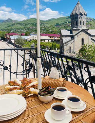 a table with plates of food and two cups of coffee at Har-Mar Hotel in Goris