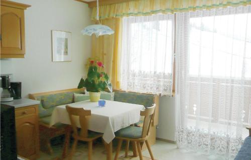 a dining room with a table and chairs and a kitchen at Beautiful Apartment In Rauris With 2 Bedrooms And Internet in Rauris
