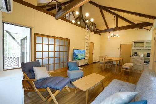 a living room with blue chairs and a table at TOSHINO RESORT Nikko in Nikko
