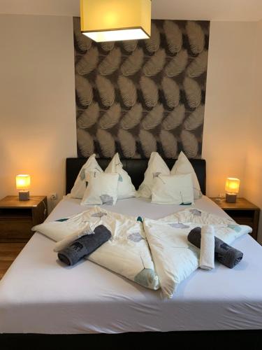 a bed with towels and pillows on top of it at Villa Eszter in Balatonkeresztúr