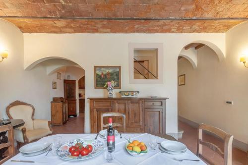 a dining room with a table with fruit on it at Fattoria la Gigliola - Il Fattore in Montespertoli