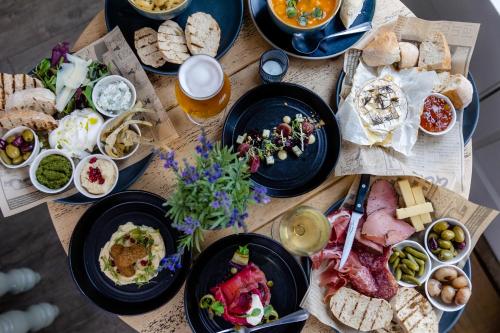 a wooden table topped with plates of food at The Bell Inn Hotel in Lyndhurst