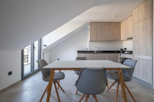 a kitchen and dining room with a table and chairs at Liberation in Pontault-Combault