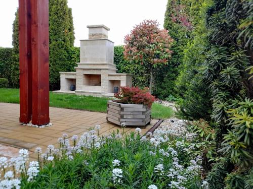 a garden with a monument in the middle at Canadian style house with 3D effect pool in Vinosady
