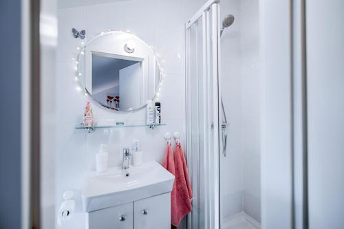 a white bathroom with a sink and a mirror at Sweet Loft Apartment (White) in Rijeka center in Rijeka