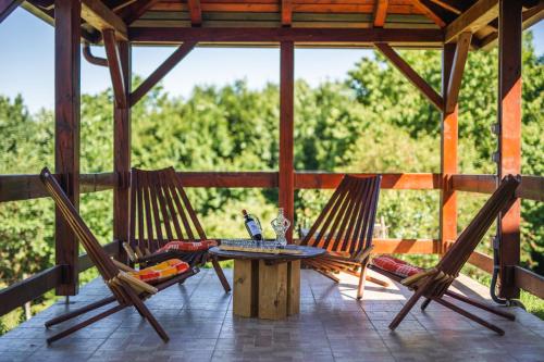 a patio with two chairs and a table on a porch at Kuća za odmor Activ in Sveti Ilija