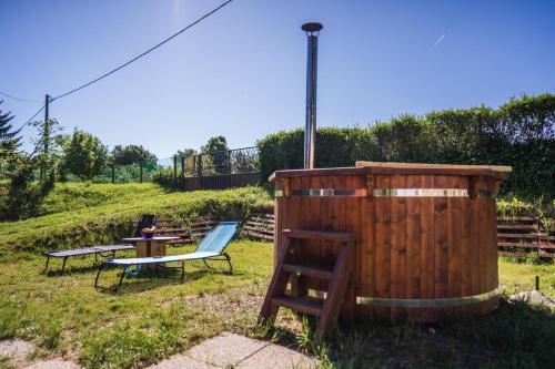 a wooden barrel and a chair and a table and a bench at Kuća za odmor Activ in Sveti Ilija