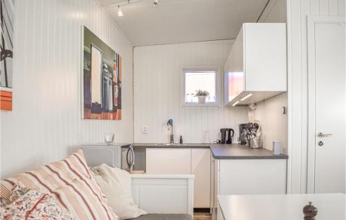 a white kitchen with a sink and a counter at Stunning Apartment In Sölvesborg in Sölvesborg