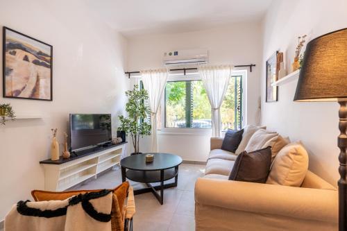 a living room with a couch and a tv at Arty Haven - Spacious 3-BR House in Larnaca in Larnaca