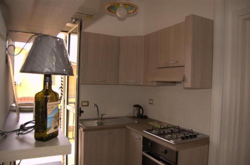 a kitchen with a lamp sitting on a counter next to a stove at B&B House of Sun in Villapiana
