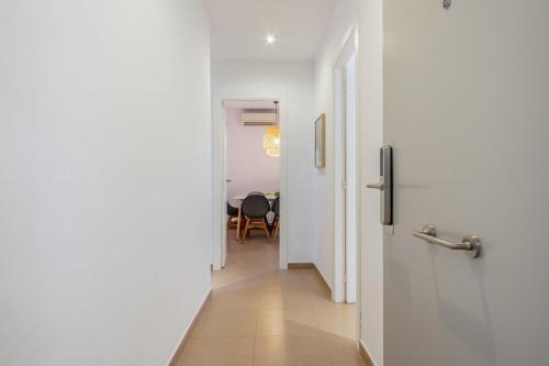 a hallway with a door leading to a dining room at Inside Barcelona Apartments Salva in Barcelona