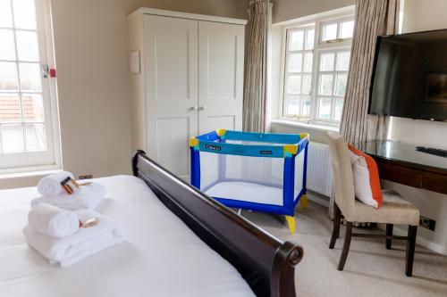 a bedroom with a bed with a play equipment on it at The Bell Inn Hotel in Lyndhurst