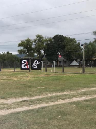 a soccer field with two signs in the grass at Apart Gallery - San Lorenzo - Salta in Salta