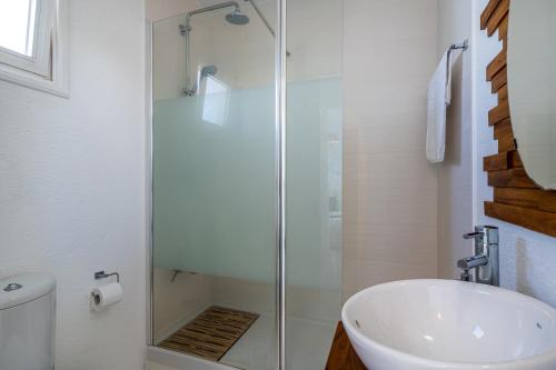 a bathroom with a glass shower and a sink at 1- Bedroom Apartment near Meneou Beach in Larnaka