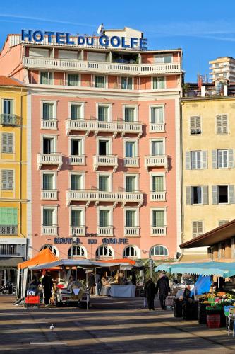 a large pink building with a sign on it at Hôtel Du Golfe in Ajaccio