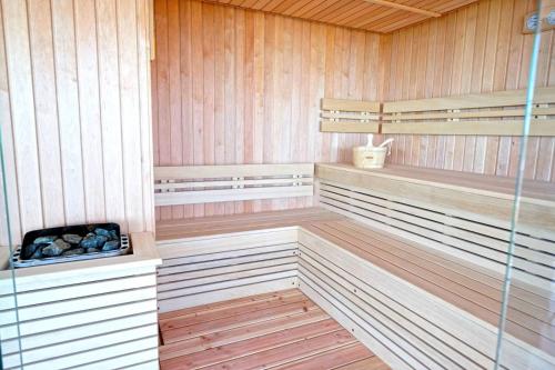 a sauna with wood paneled walls and wooden floors at Paradise Hotel & Relax Center in Pomorie