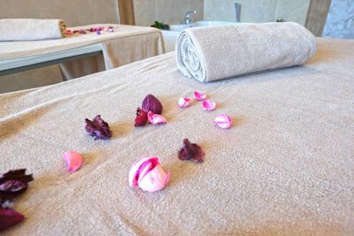 a group of pink flowers on a bed at Paradise Hotel & Relax Center in Pomorie