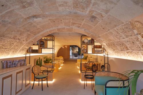 a room with a stone ceiling with chairs and tables at Fil Suites in Palma de Mallorca