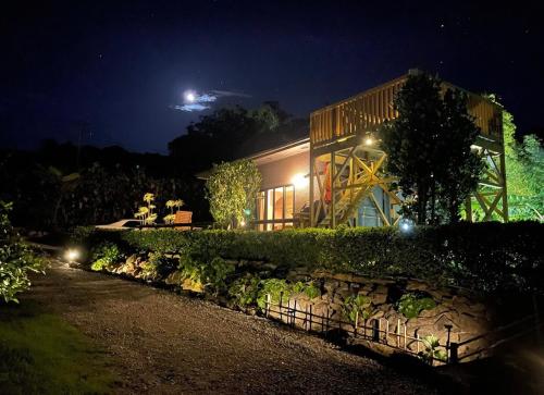 a house at night with a stone wall at Private Villa Churaya Yaedake Bettei with 500sqm garden in Motobu