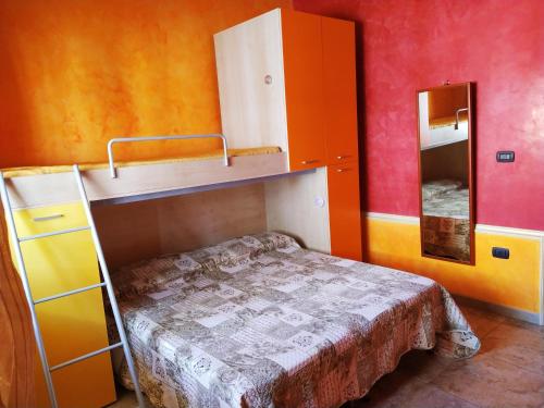 a small room with a bunk bed and a mirror at Casa Vacanze da Antonio in Torre Lapillo