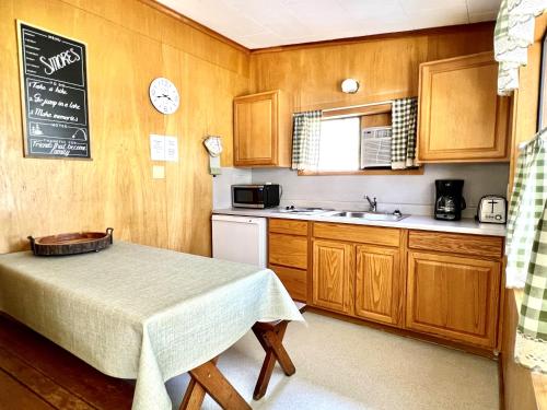 a small kitchen with a table and a sink at Willow Springs Resort in Bridgeport
