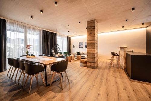 een eetkamer en een woonkamer met een tafel en stoelen bij GRIMMINGlofts in Bad Mitterndorf