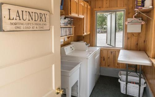 a laundry room with a washing machine and a window at Willow Springs Resort in Bridgeport