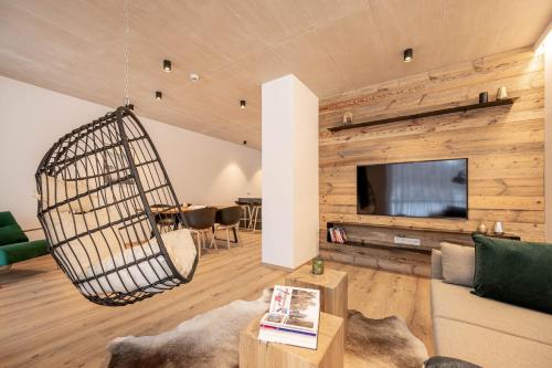 a living room with a swing hanging from the ceiling at GRIMMINGlofts Top 7 in Bad Mitterndorf
