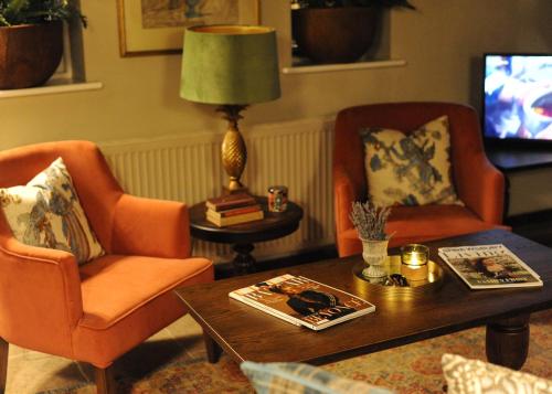 a living room with two chairs and a coffee table at The Lion at Malpas in Malpas