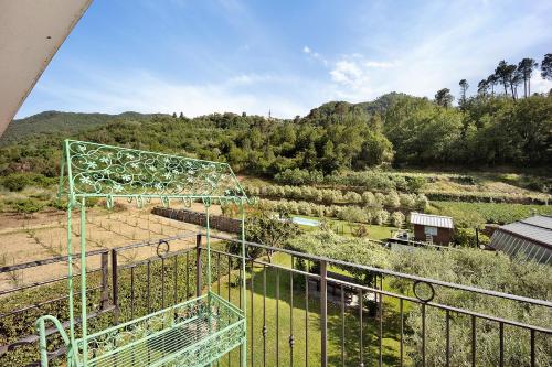 a balcony with a view of a field and trees at Mansarda Albero Verde con Piscina in Casanova Lerrore