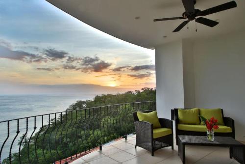 a balcony with two chairs and a view of the ocean at Playa Flamingo - 2 BR condo with great ocean views - FLAMINGO TOWERS 25 in Playa Flamingo