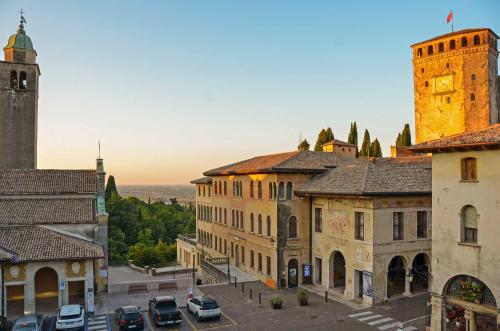 a view of a city with a clock tower and buildings at Palazzo Benassi Penthouse in Asolo
