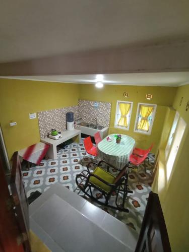 a living room with a table and chairs in a room at Rumah Gadang Tokama, Simarasok in Baso
