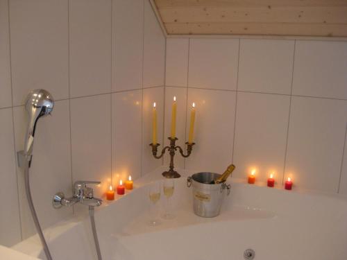 a bath tub with candles and wine glasses on it at Sonnendeck in Greetsiel