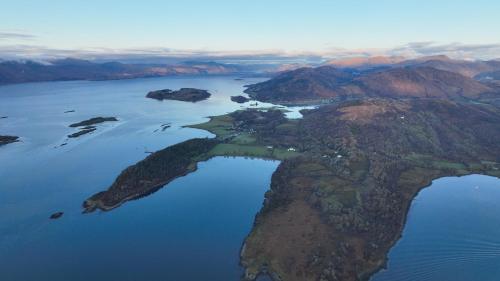 an island in the middle of a body of water at Coachmans Bothy - 50m from the beach in Port Appin