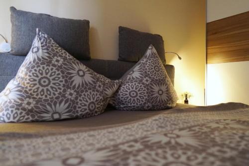 a bed with two pillows on top of it at Dat Diekhus in Greetsiel
