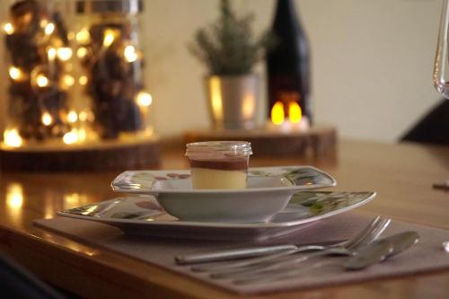 a cup of coffee on a plate on a table at Dat Diekhus in Greetsiel
