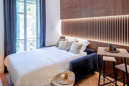 une chambre avec un grand lit et une table dans l'établissement Superbe studio Plage/ Promenade des Anglais 104, à Nice