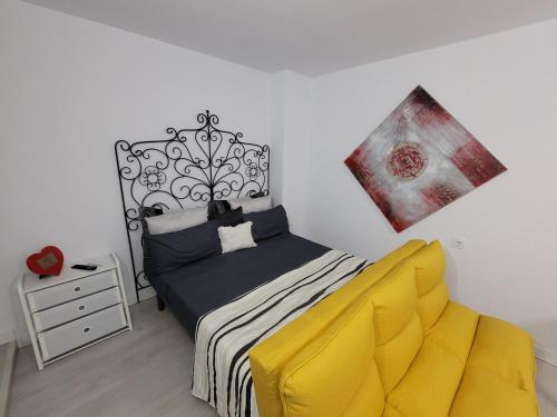 sypialnia z łóżkiem i obrazem na ścianie w obiekcie Apartamento ClaVer w mieście Vejer de la Frontera