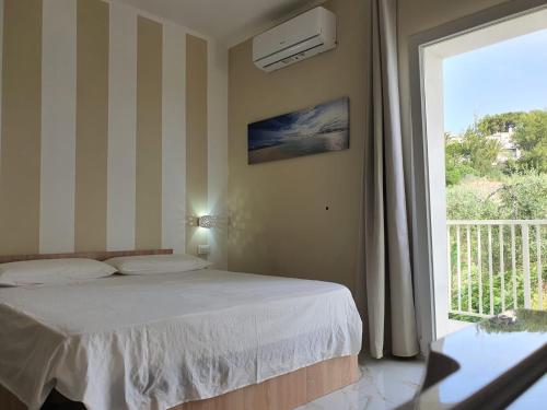 a bedroom with a bed and a large window at B&B La Leggenda in Vieste