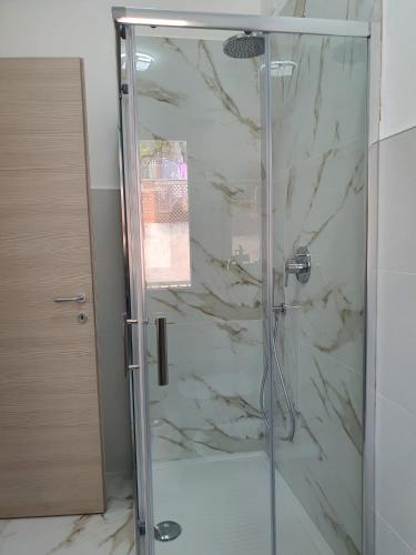 a shower with a glass door in a bathroom at B&B La Leggenda in Vieste
