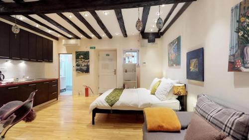 a bedroom with a bed and a couch in a room at Diocletian Studio Apartments in Split